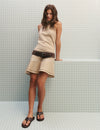 Short dress with asymmetrical hem and draped neckline
