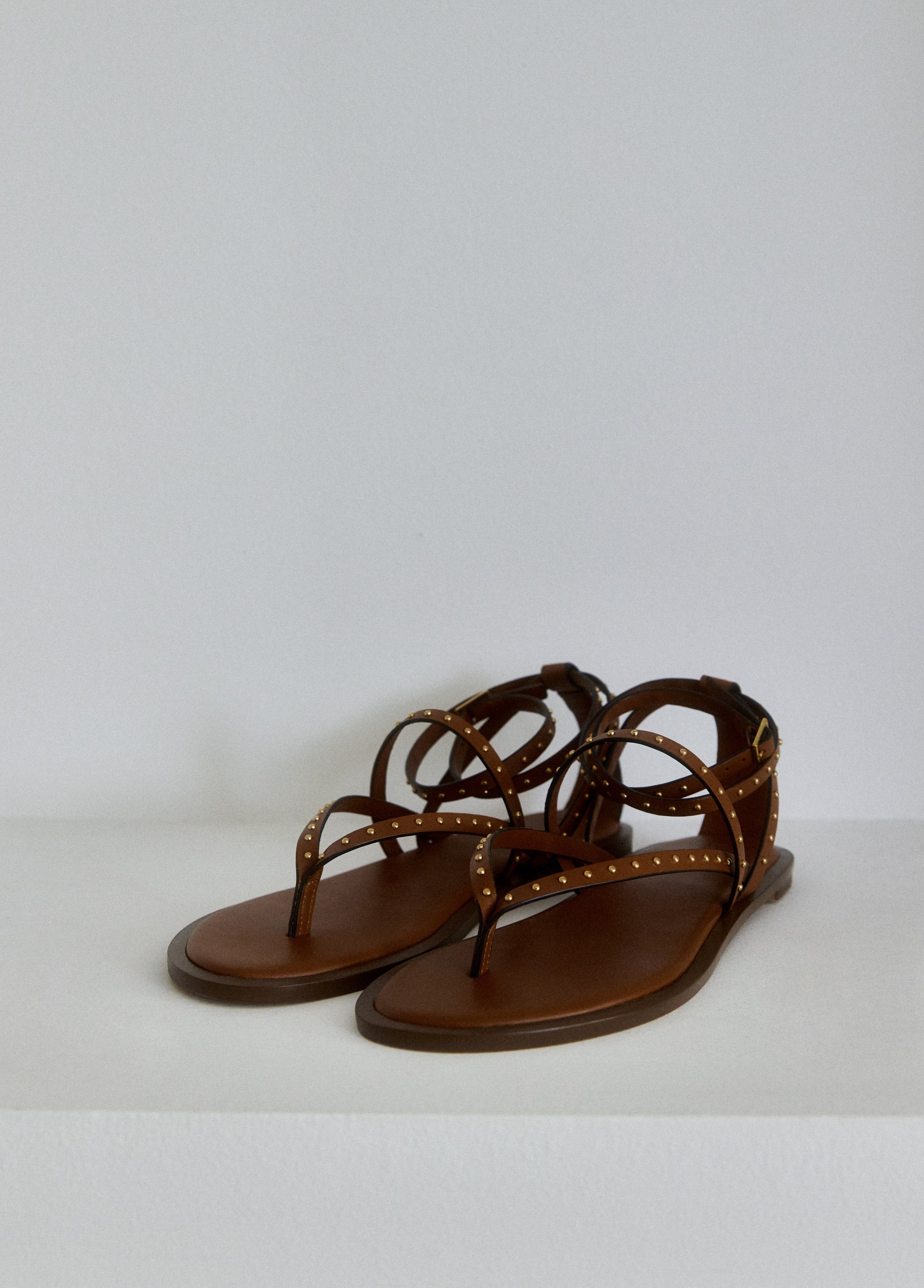 Flat sandal with studded straps