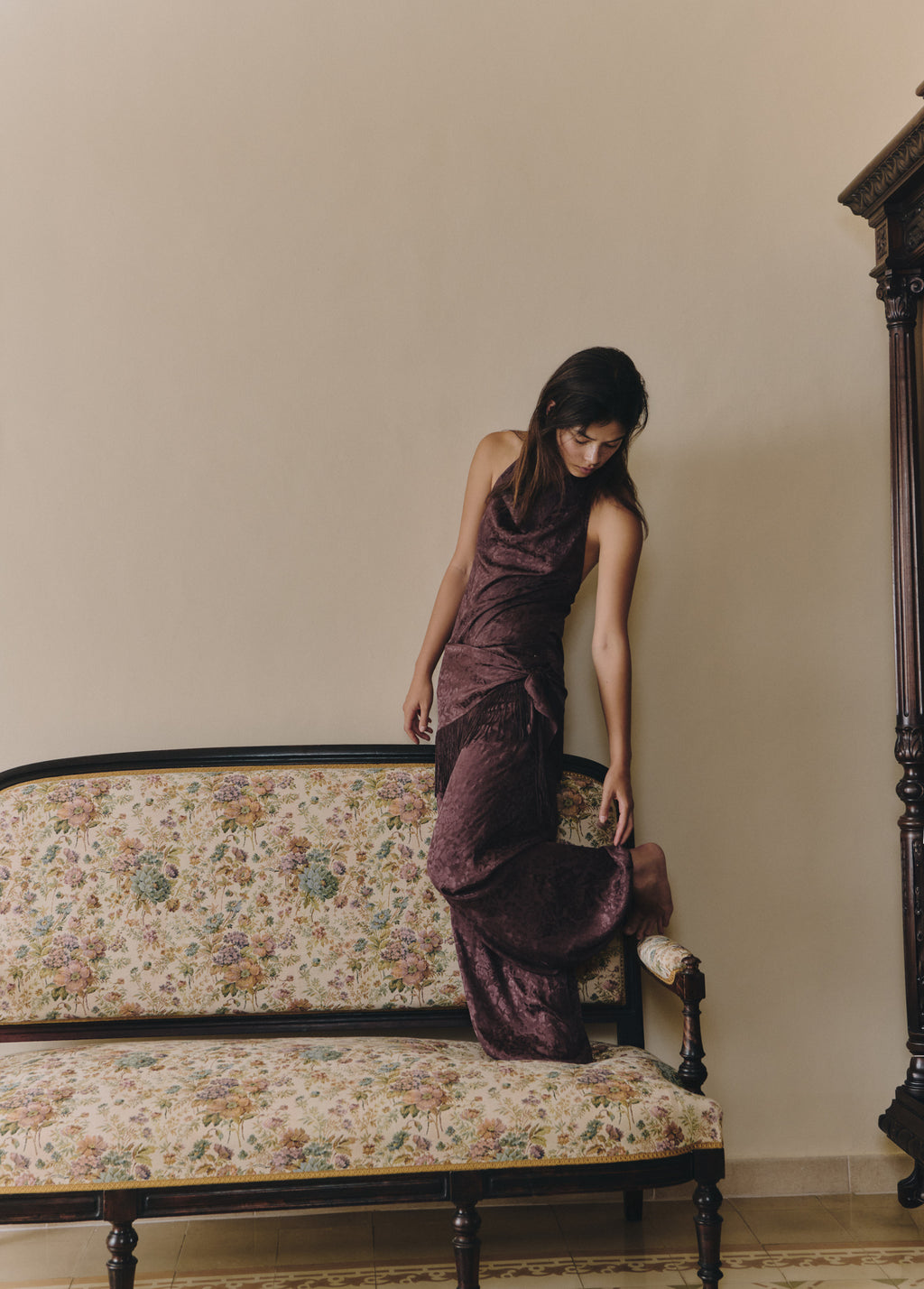 Top halter tejido jacquard de color marrón lucido en su caída fluida sobre una butaca floral
