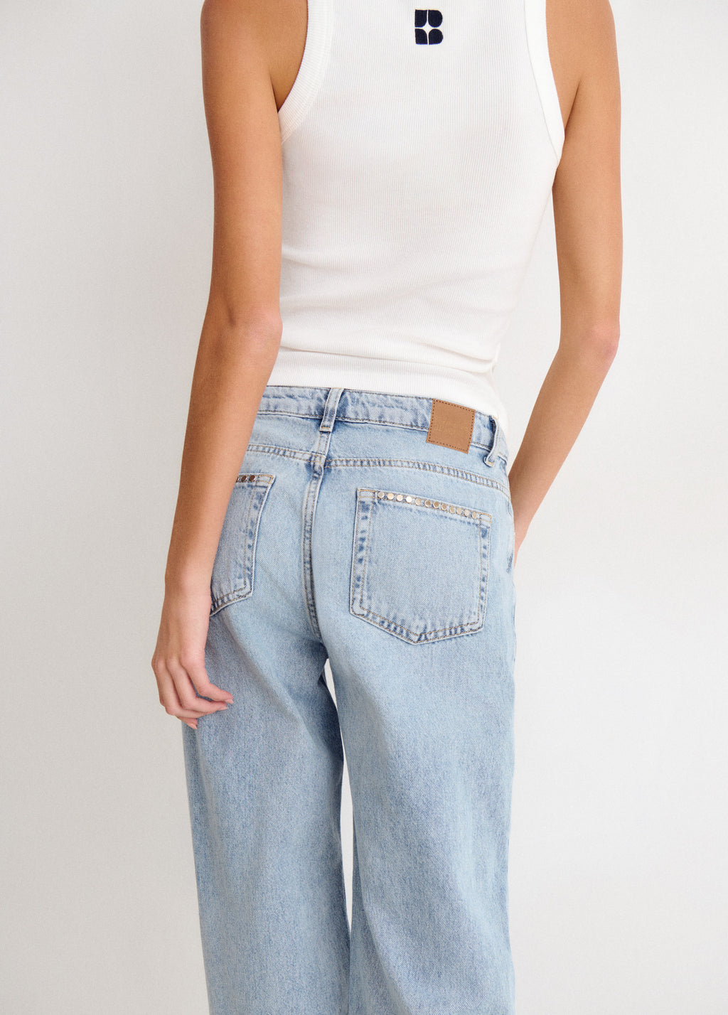 Relaxed jeans with studs and folded hem