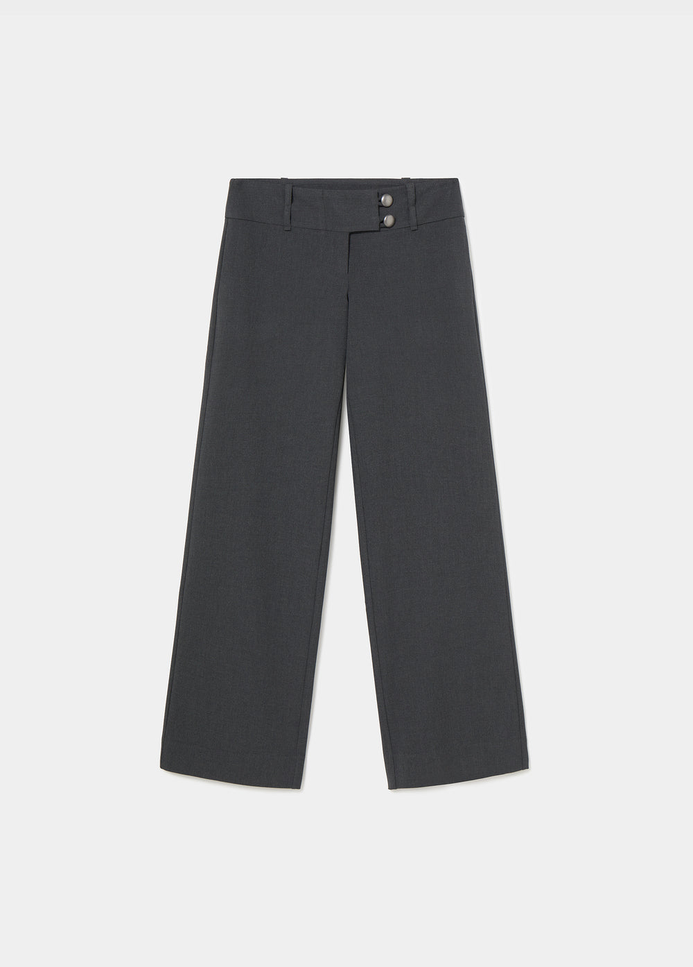 Pantalón de tiro bajo y pierna ancha en gris oscuro, visto de frente con las manos en los bolsillos