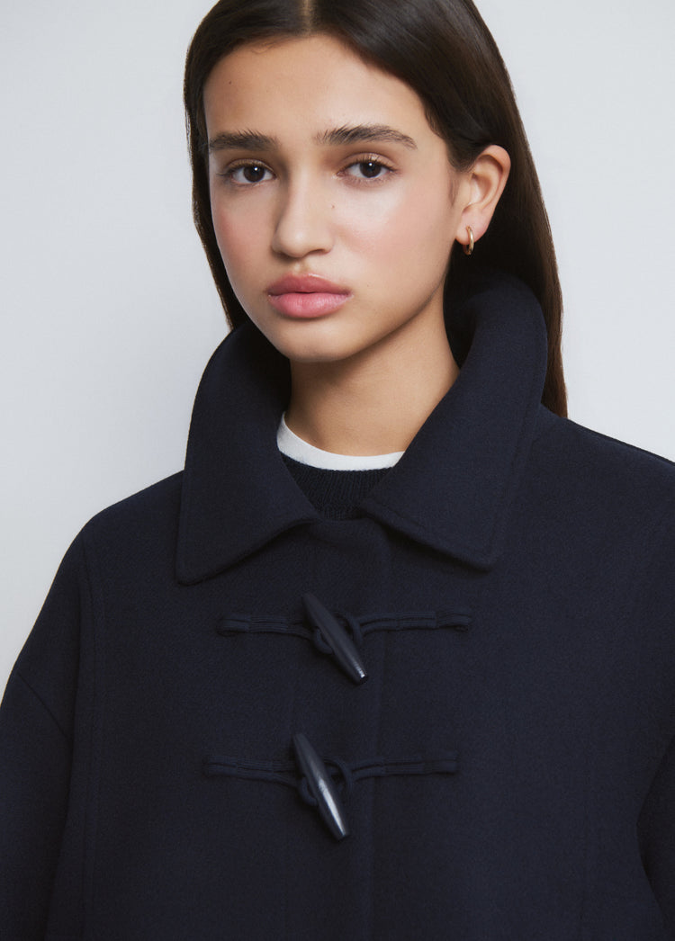 Short coat with toggle fastenings