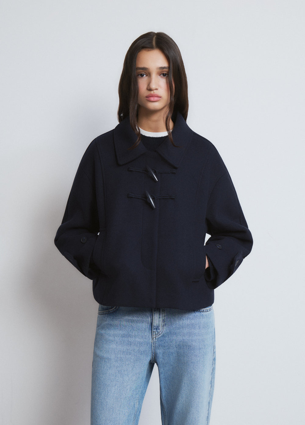 Short coat with toggle fastenings
