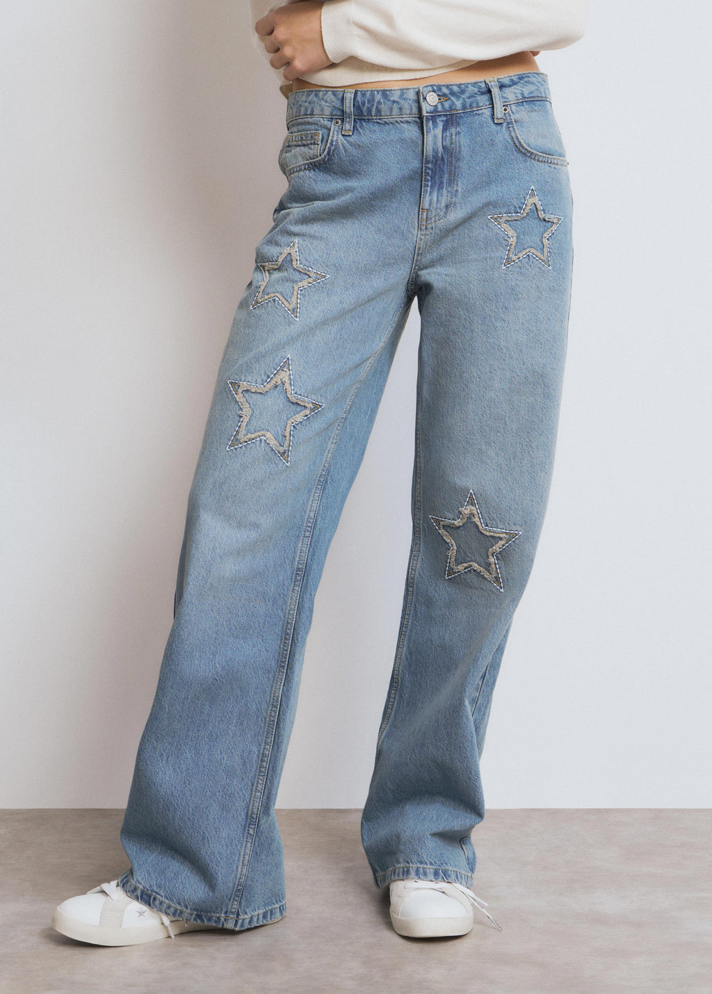Jeans met sterpatch en rafels