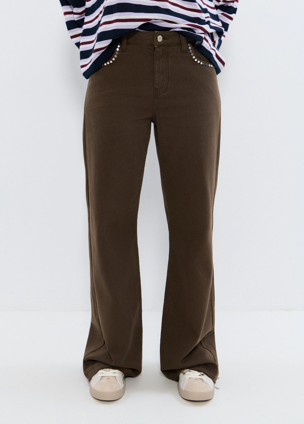 Relaxed pants with studs and rolled-up hem