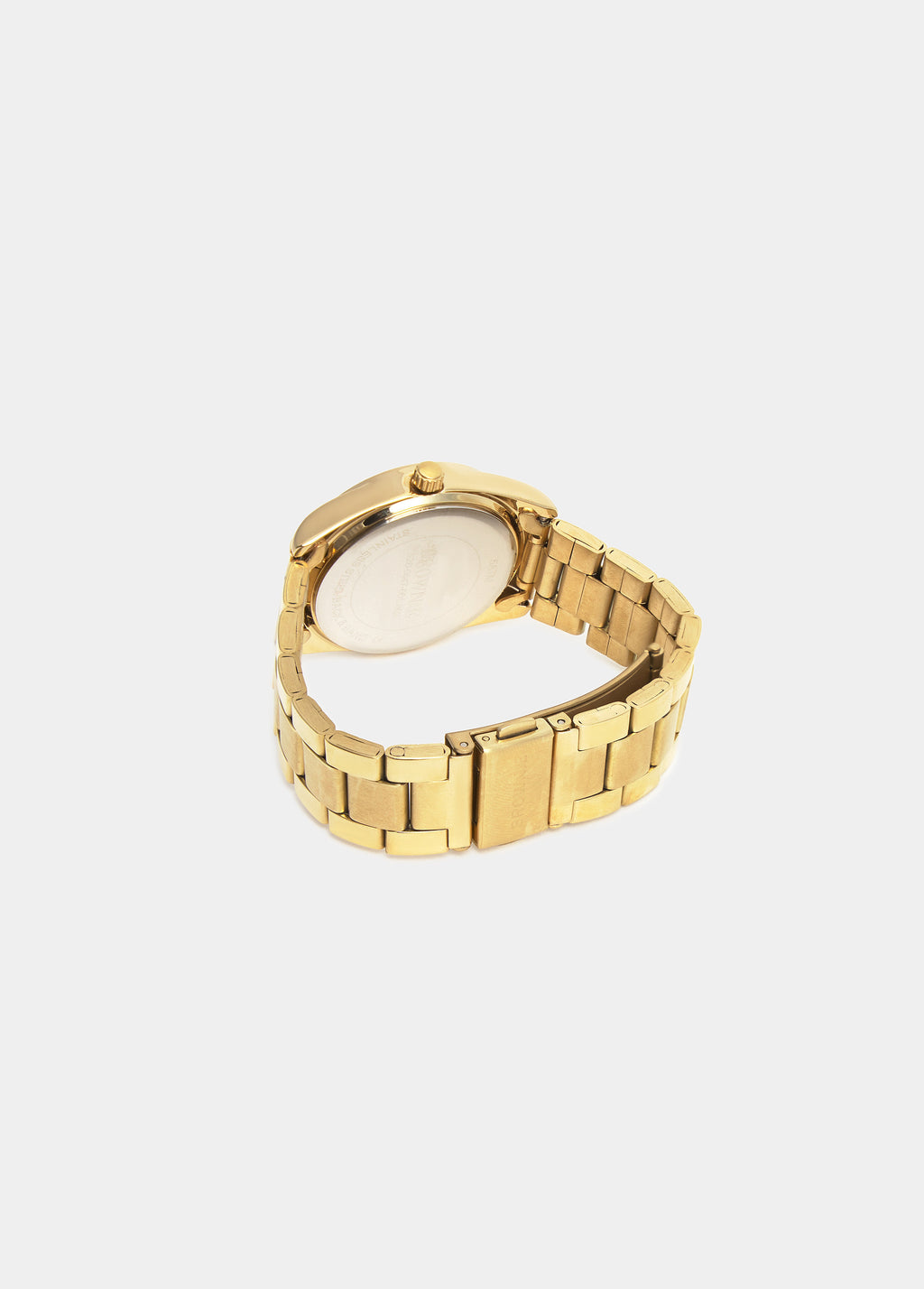 Reloj de pulsera dorado visto por detrás mostrando la correa y el fondo