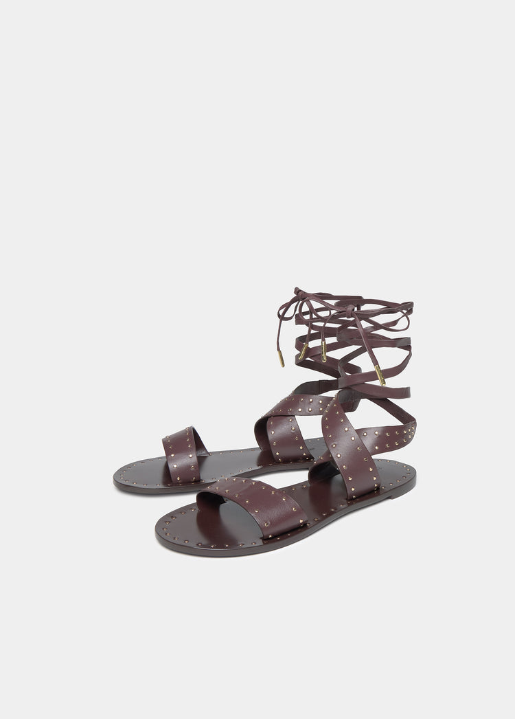 Flat sandals with studs and ties