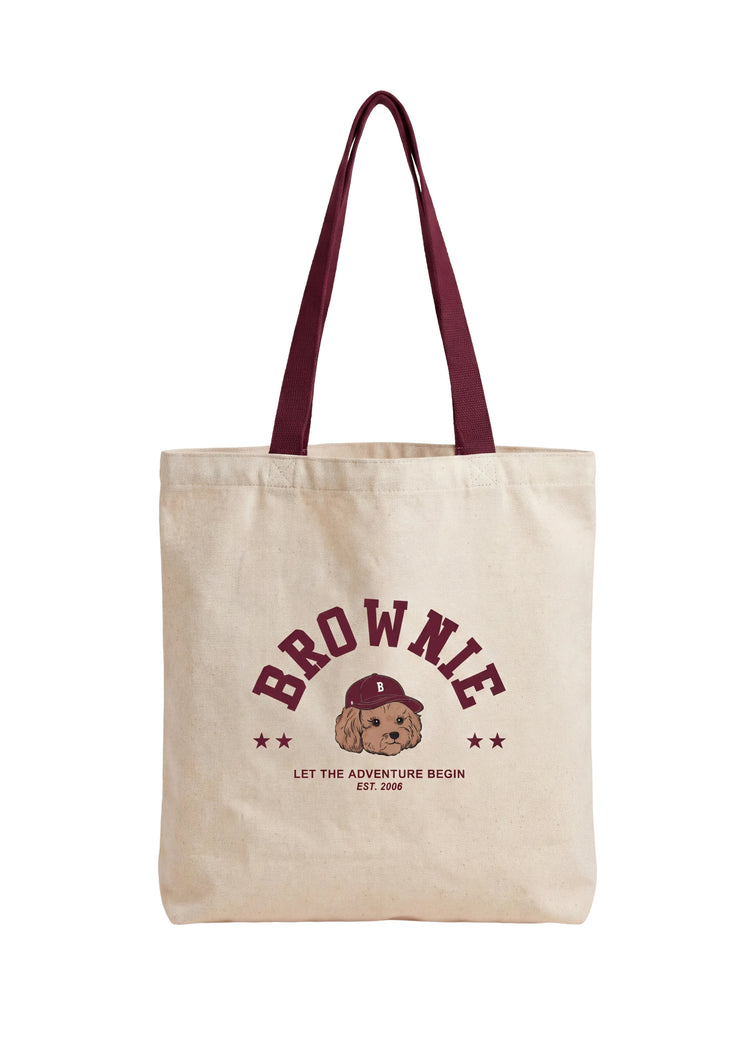 Bolso de tela blanca con estampado de un perrito y la palabra brownie en rojo